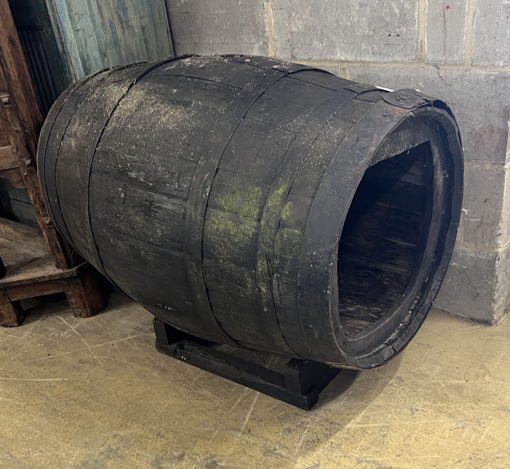 A vintage coopered wine barrel on stand, now converted to a dog's kennel, width 96cm, height 76cm